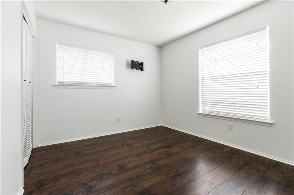6005 Hogan Avenue Austin, TX 78741 - Photo 5 of 19 an empty room with wooden floor and windows