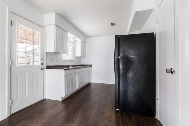 a kitchen with a refrigerator and window