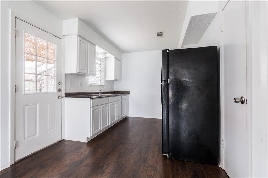 6005 Hogan Avenue Austin, TX 78741 - Photo 8 of 19 a kitchen with a refrigerator and window