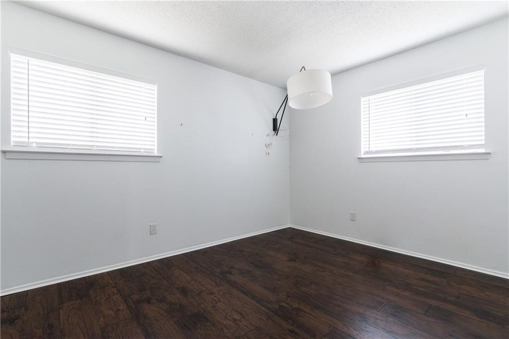 6005 Hogan Avenue Austin, TX 78741 - Photo 9 of 19 an empty room with wooden floor and windows