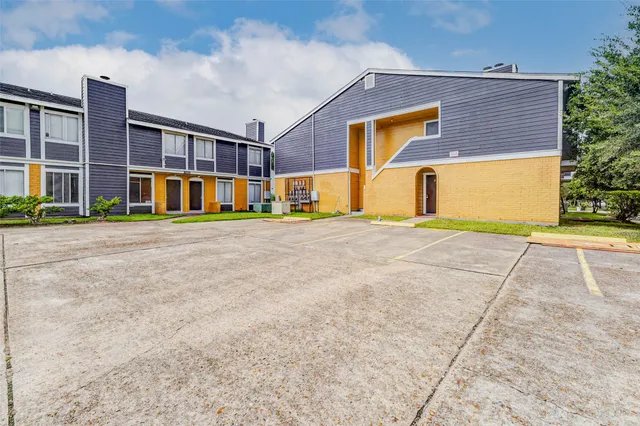 a view of pool with yard in front of it