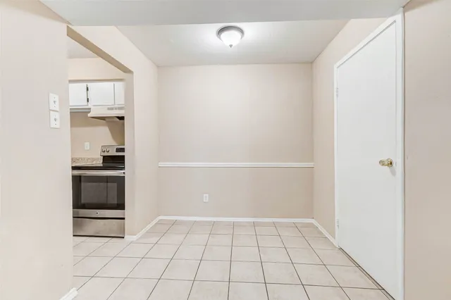 a view of a kitchen with white cabinets and white appliances