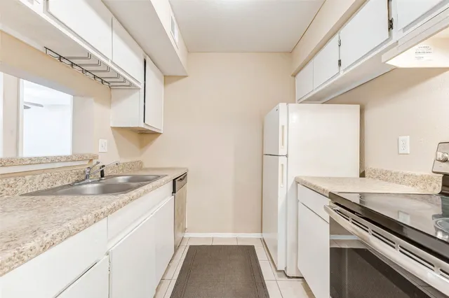 a kitchen with a sink and a refrigerator