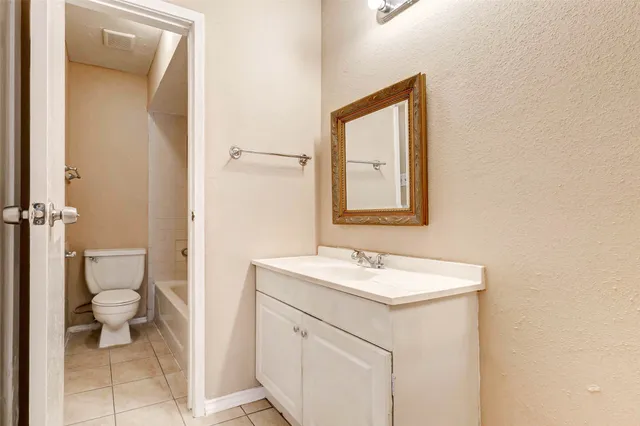 a bathroom with a toilet sink and a mirror