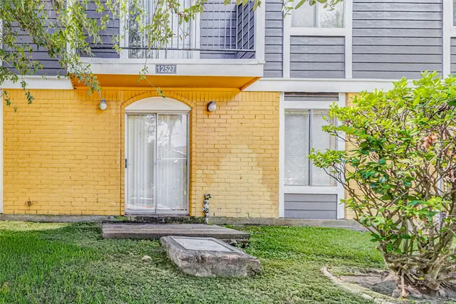 a view of a house with backyard and sitting area