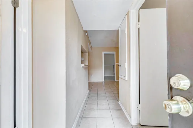 a view of a hallway with wooden floor and closet