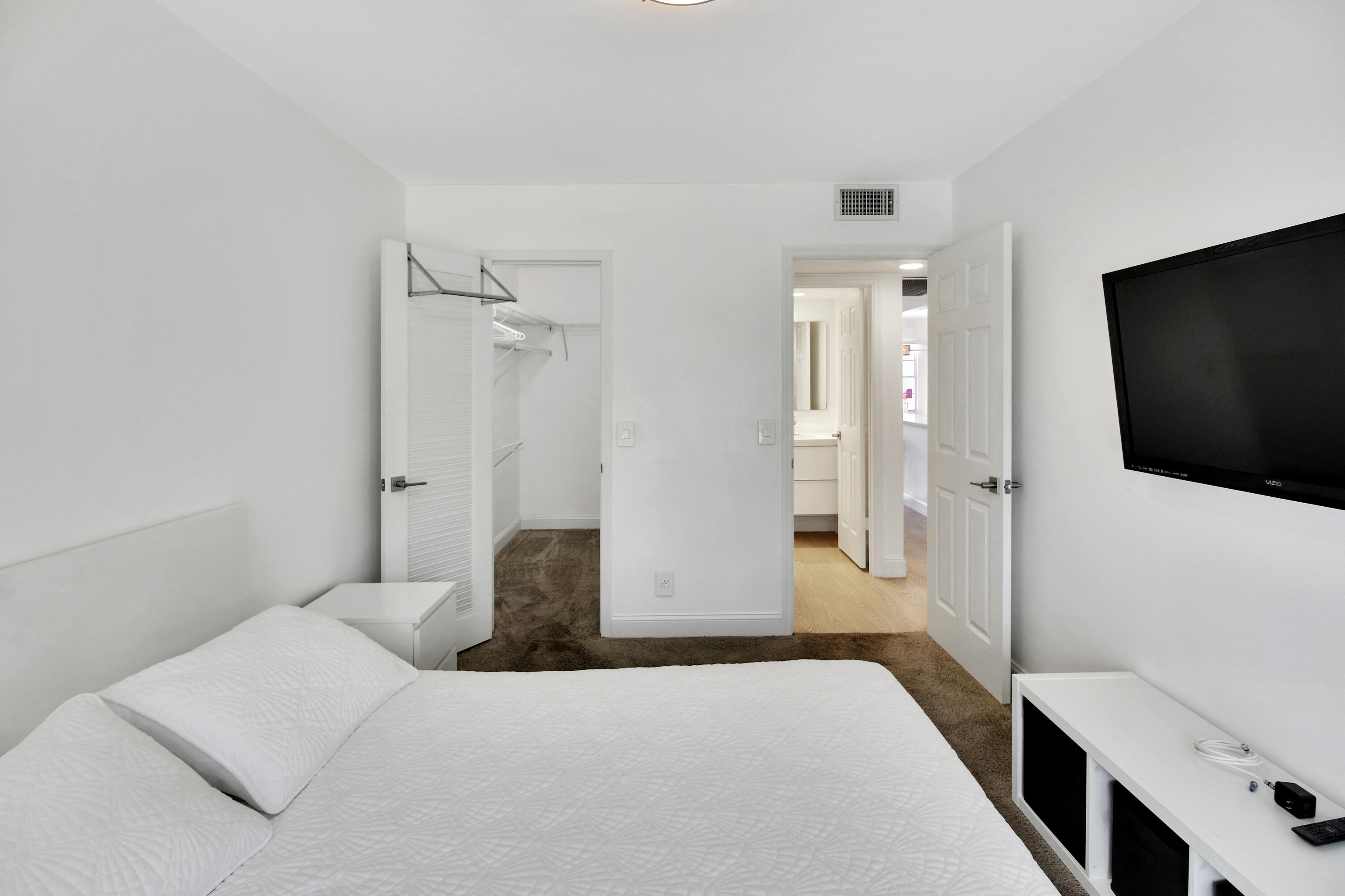 17 Fanshaw A Boca Raton, FL 33434 - Photo 7 of 11 a bedroom with a bed and a flat screen tv