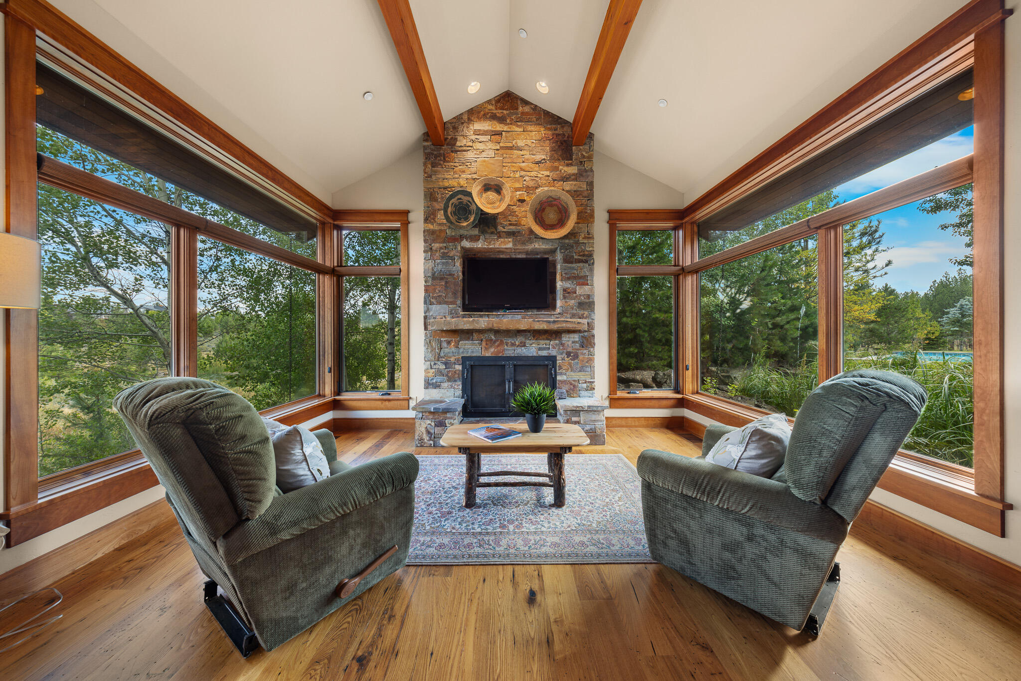 18883 Sutherland Court Bend, OR 97702 - Photo 41 of 70 Open-concept living surrounded by walls of glass and a striking stone fireplace?nature meets comfort.