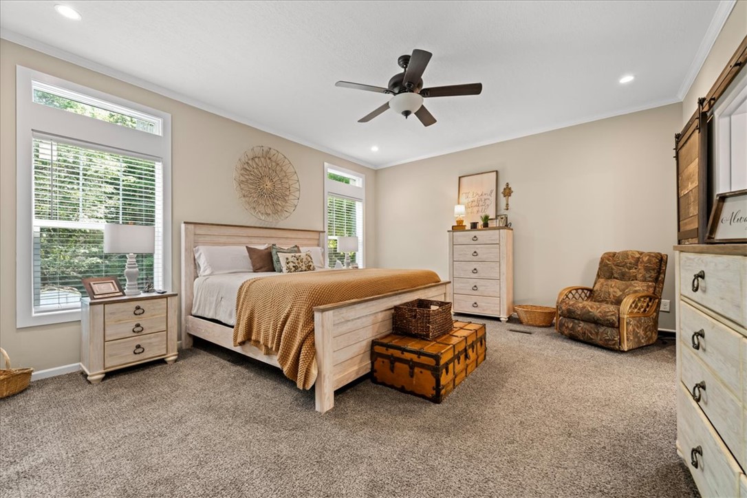 116 Parkview Road Iva, SC 29655 - Photo 19 of 44 Comfortable main bedroom with plush carpeting and a modern ceiling fan, offering a serene personal retreat.