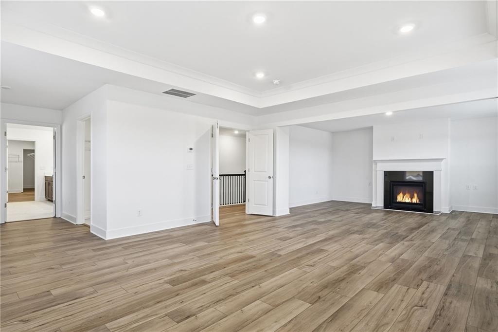 259 Deer Valley Run Canton, GA 30115 - Photo 11 of 25 a view of empty room with wooden floor and fireplace