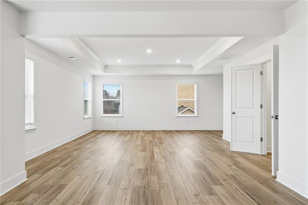 259 Deer Valley Run Canton, GA 30115 - Photo 12 of 25 an empty room with wooden floor and windows
