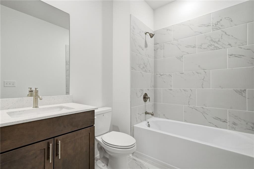 259 Deer Valley Run Canton, GA 30115 - Photo 22 of 25 a bathroom with a sink a toilet and a bathtub