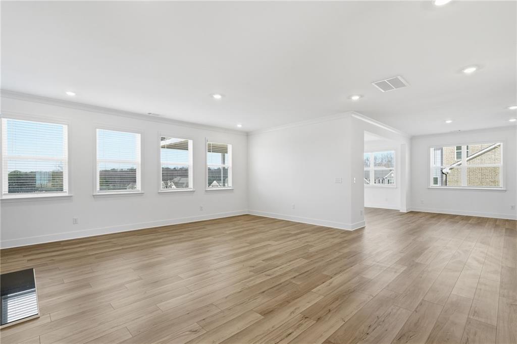 259 Deer Valley Run Canton, GA 30115 - Photo 7 of 25 a view of an empty room with wooden floor and a window