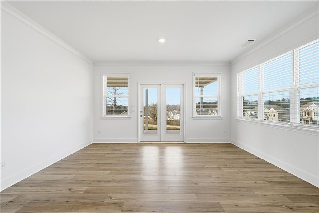259 Deer Valley Run Canton, GA 30115 - Photo 9 of 25 a view of an empty room with wooden floor and a window