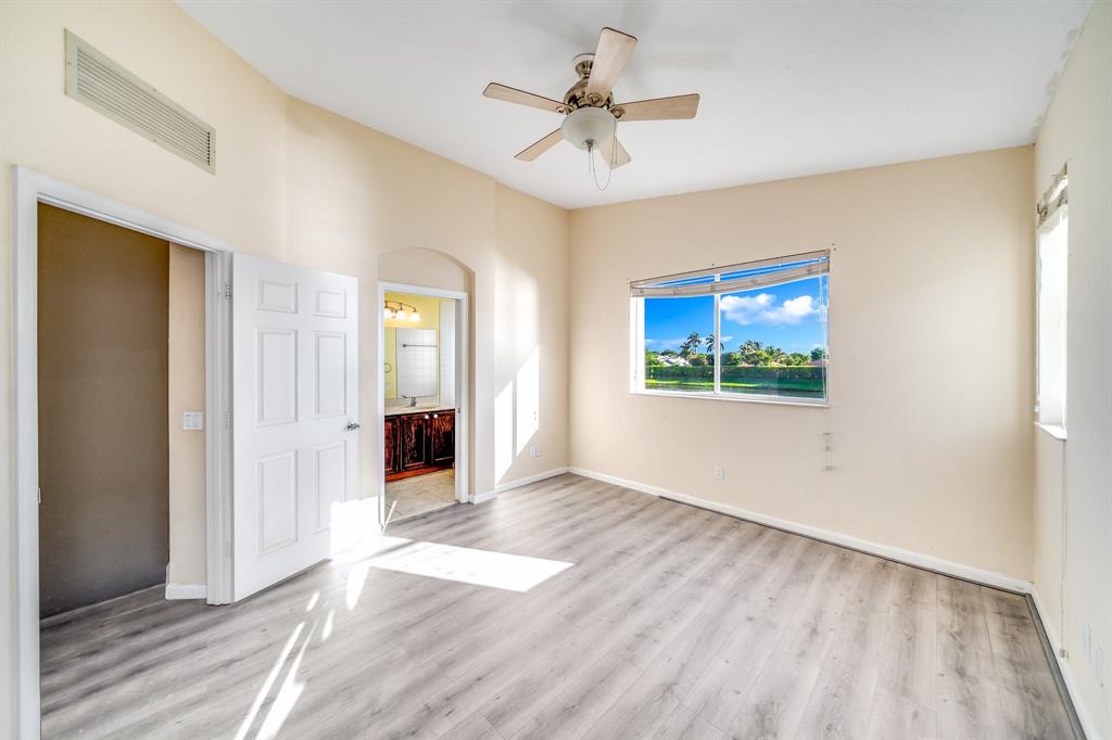 3141 Laurel Ridge Circle Riviera Beach, FL 33404 - Photo 11 of 28 wooden floor in an empty room with a window