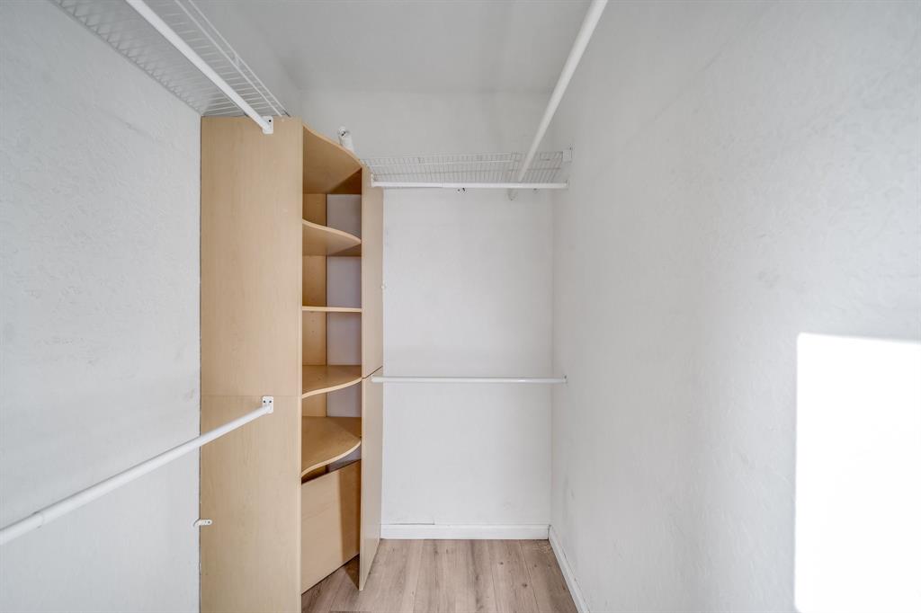 3141 Laurel Ridge Circle Riviera Beach, FL 33404 - Photo 12 of 28 a room with walk in closet and wooden floor