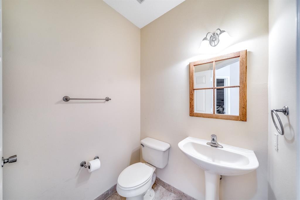 3141 Laurel Ridge Circle Riviera Beach, FL 33404 - Photo 16 of 28 a bathroom with a sink mirror and toilet
