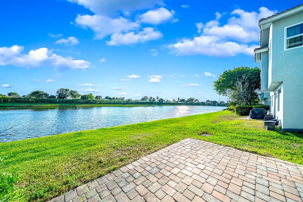 3141 Laurel Ridge Circle Riviera Beach, FL 33404 - Photo 20 of 28 a view of a lake with a yard