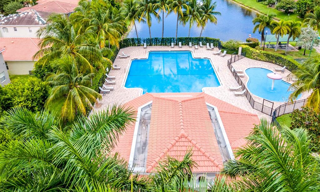 3141 Laurel Ridge Circle Riviera Beach, FL 33404 - Photo 22 of 28 a view of a swimming pool with sitting area