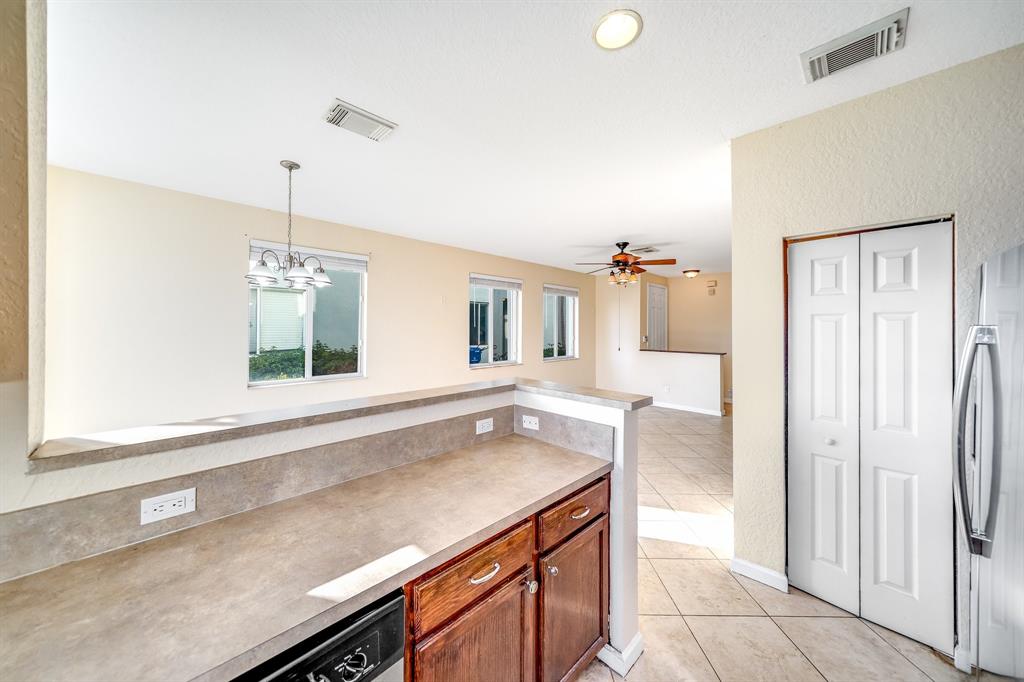 3141 Laurel Ridge Circle Riviera Beach, FL 33404 - Photo 6 of 28 a kitchen with a sink and a refrigerator