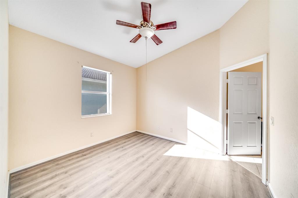 3141 Laurel Ridge Circle Riviera Beach, FL 33404 - Photo 10 of 28 wooden floor in an empty room with a window