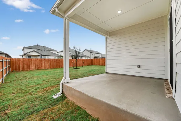 a view of a backyard with table and chairs