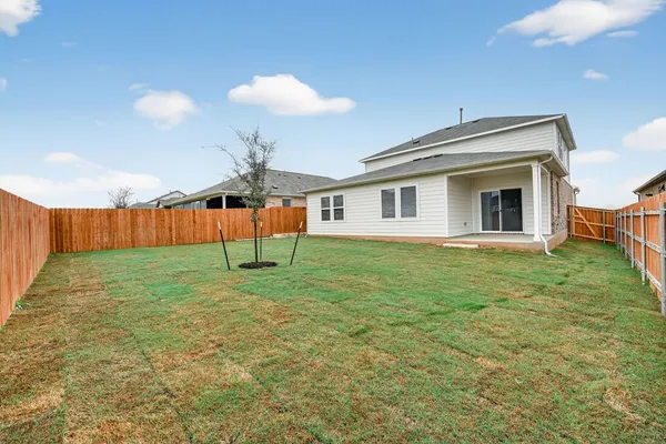 a view of a backyard with table and chairs