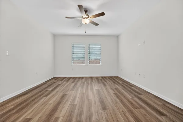wooden floor in an empty room with a window