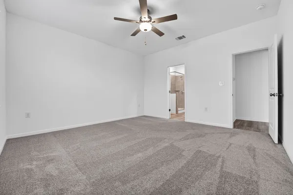 a view of an empty room with a ceiling fan