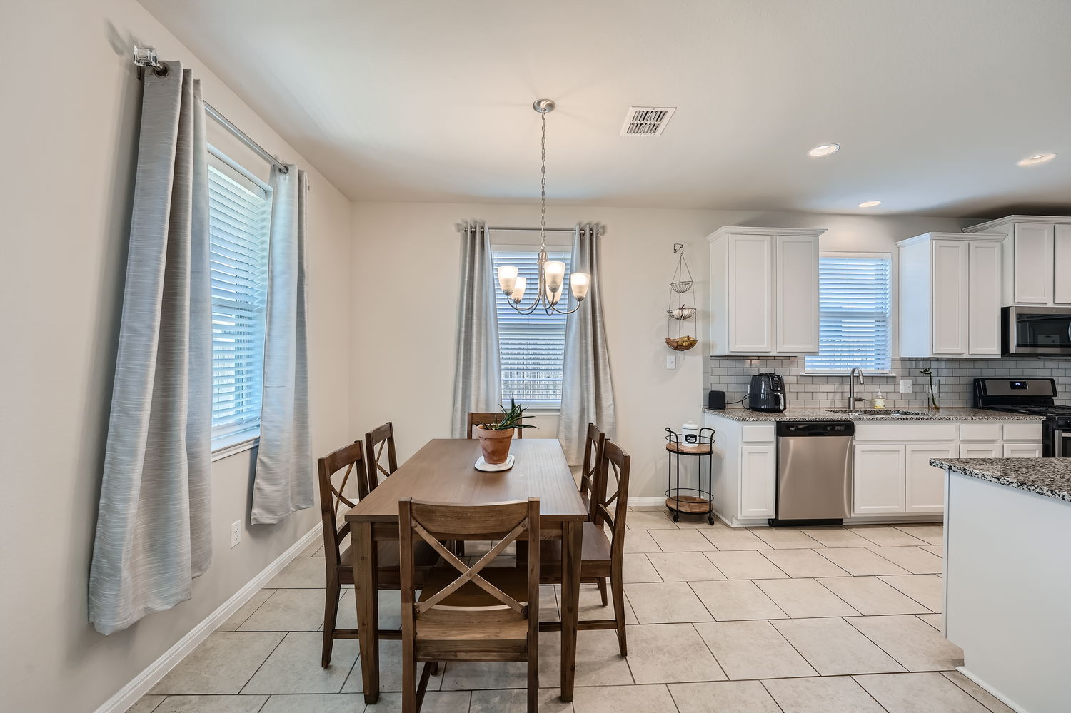 1205 Falconer Way, Unit 91 Austin, TX 78748 - Photo 11 of 39 Dining area with light tile patterned floors and hanging lights
