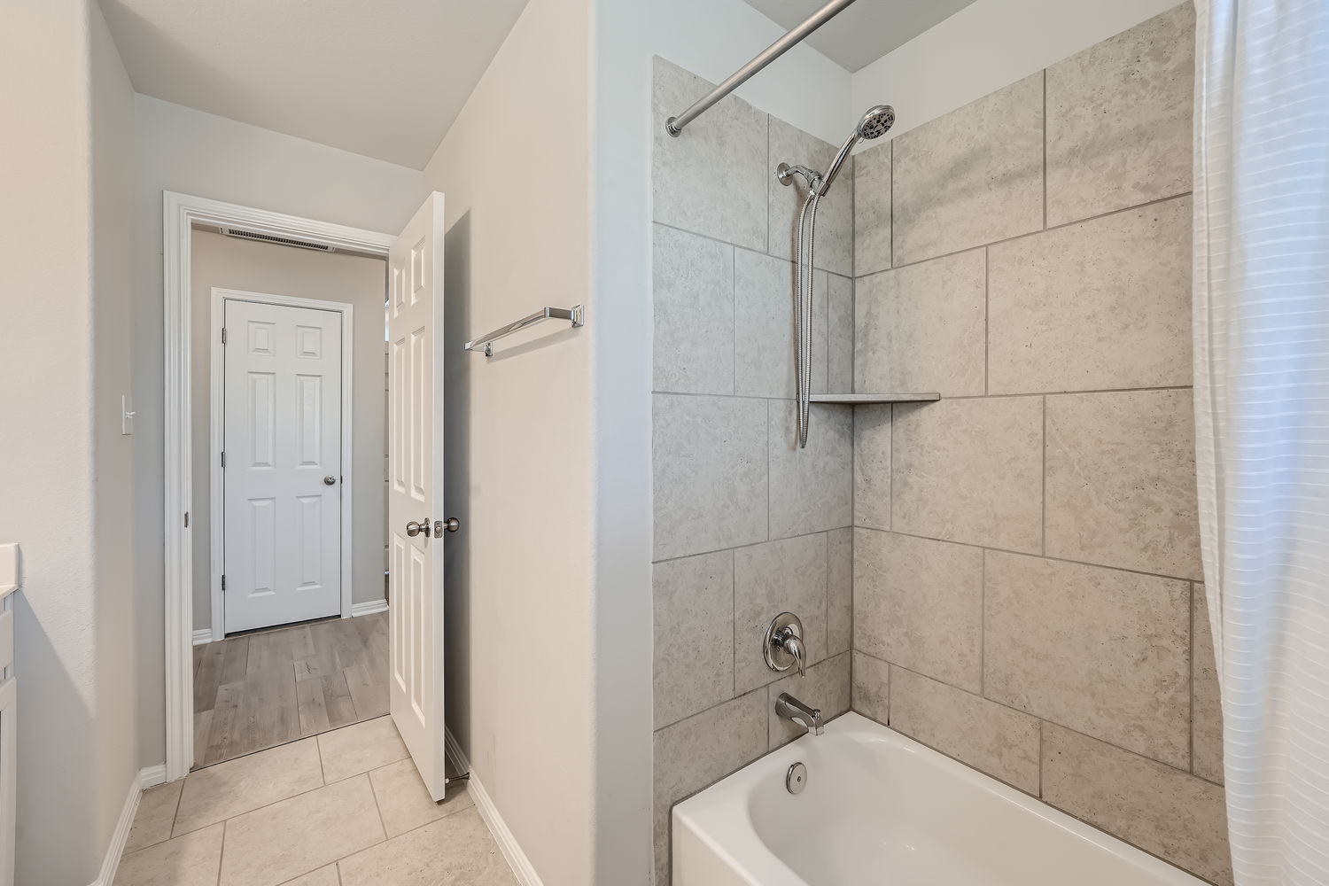 1205 Falconer Way, Unit 91 Austin, TX 78748 - Photo 31 of 39 Full bathroom with shower / bath combination with curtain, light tile patterned floors, and vanity
