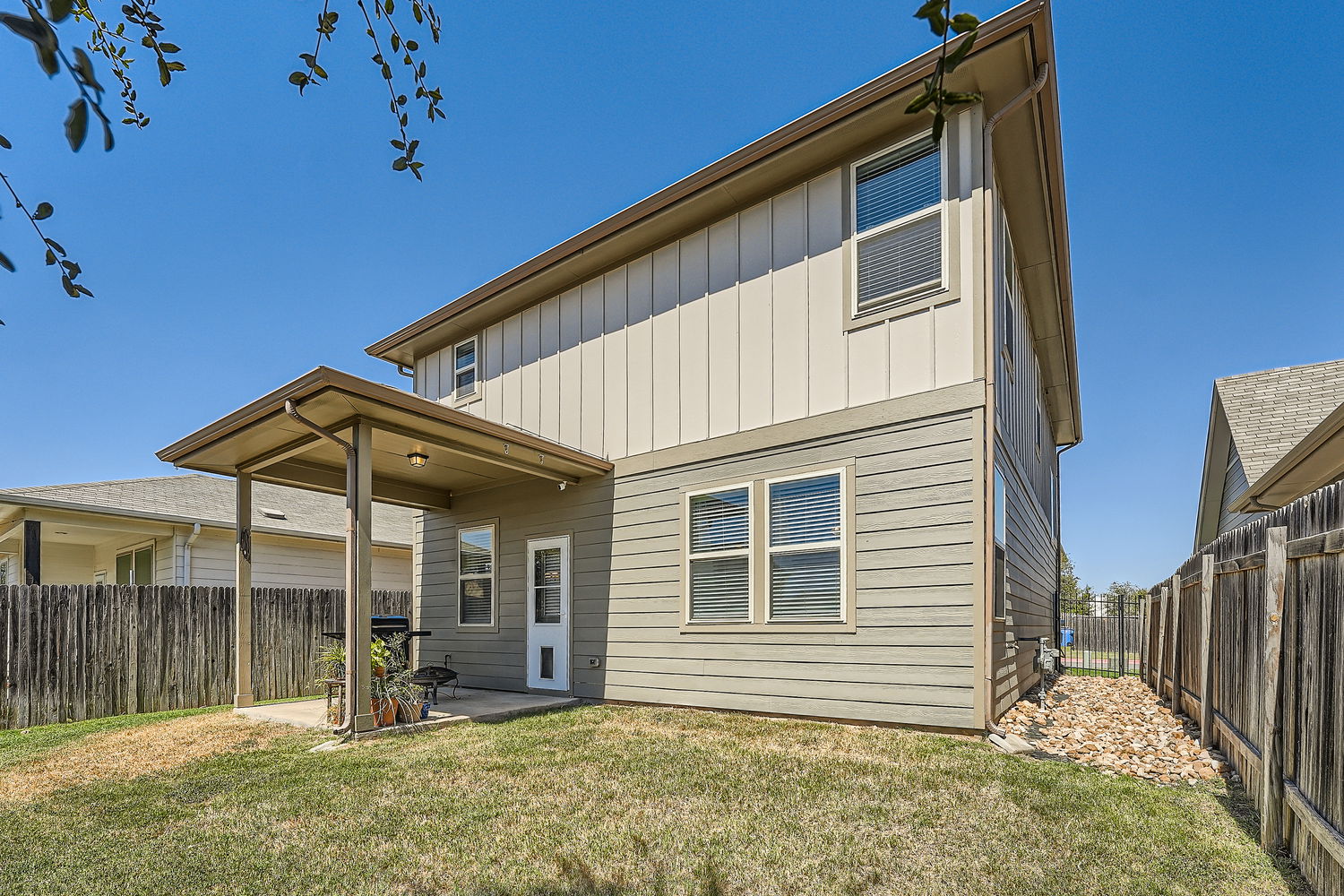 1205 Falconer Way, Unit 91 Austin, TX 78748 - Photo 38 of 39 Back of property featuring a patio, board and batten siding, and a fenced backyard