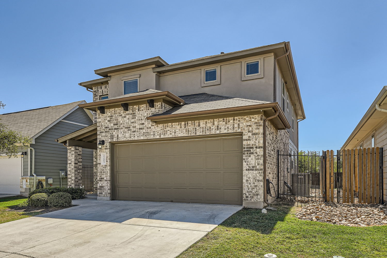 1205 Falconer Way, Unit 91 Austin, TX 78748 - Photo 4 of 39 View of front of home with brick siding, driveway, and stucco siding. Stand alone unit.
