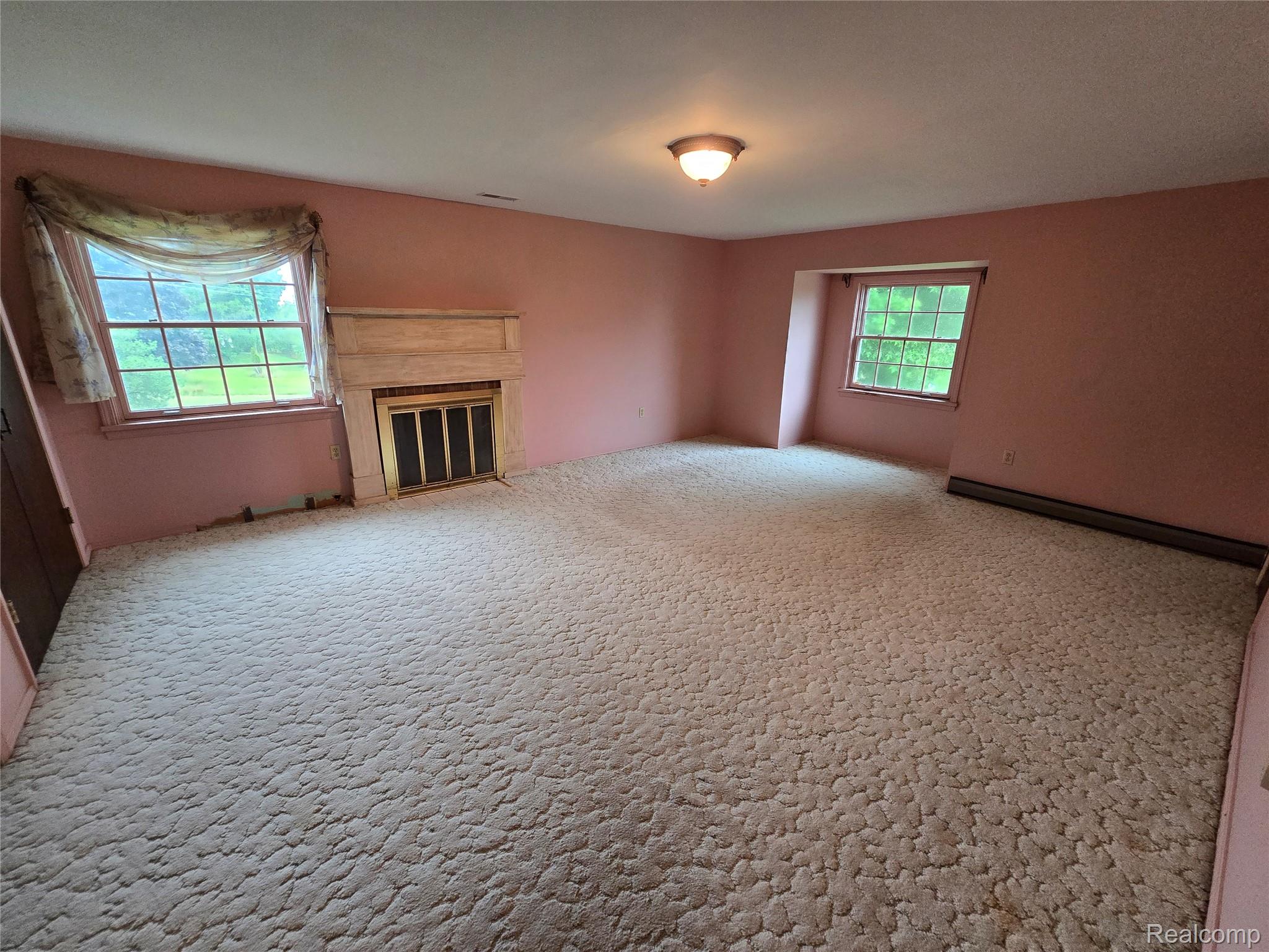 5282 McIntyre Road North Street, MI 48049 - Photo 37 of 53 Room featuring a built-in fireplace, two windows, and a flush mount ceiling light