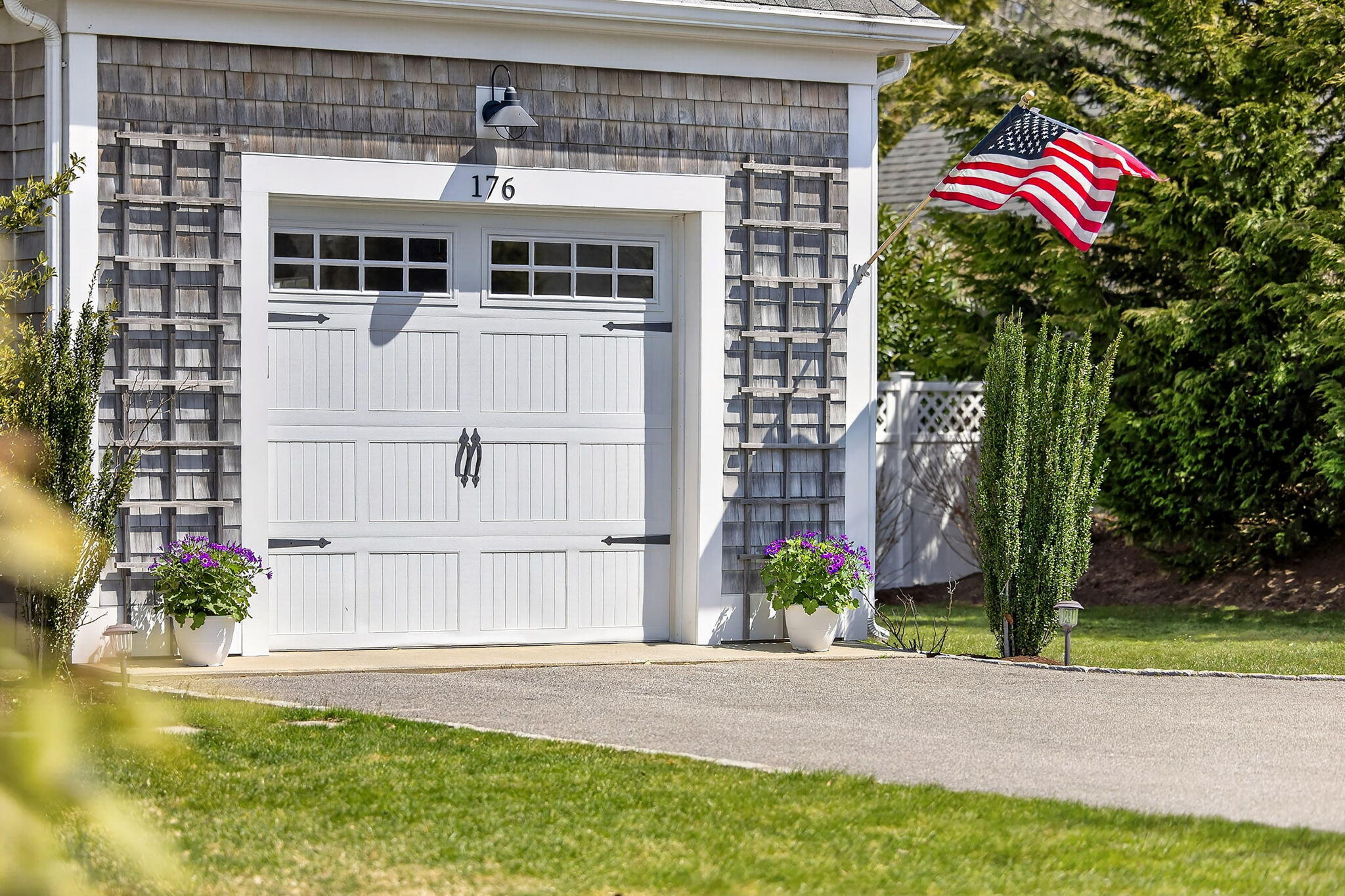 176 Bumps River Road Osterville, MA 02655 - Photo 5 of 54 a front view of a house with a yard and a garage
