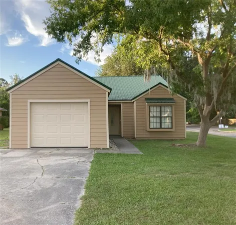 a front view of a house with a garden and yard