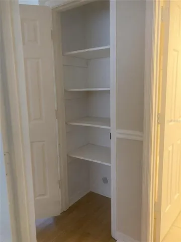 a view of walk in closet with empty racks