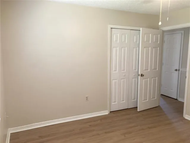 an empty room with wooden floor