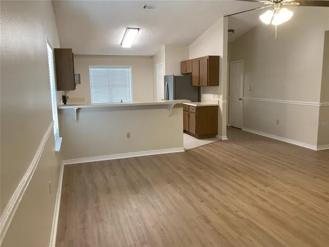 a view of a kitchen with a sink and a refrigerator