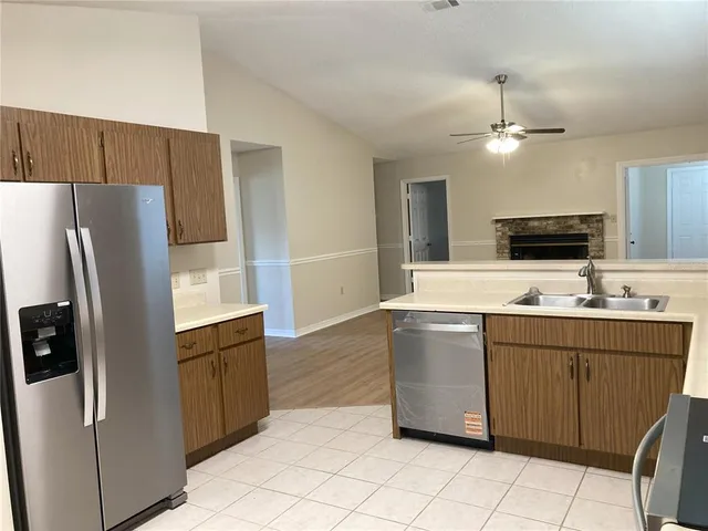 a kitchen with stainless steel appliances a refrigerator sink and microwave