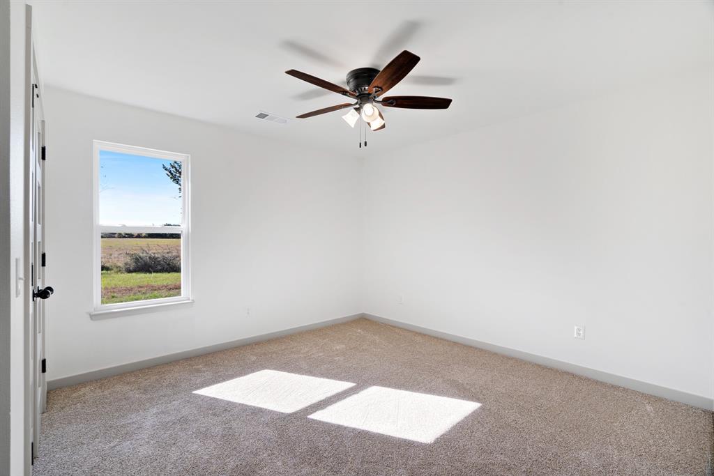728 County Road Powderly, TX 75473 - Photo 14 of 19 an empty room with a window and a ceiling fan