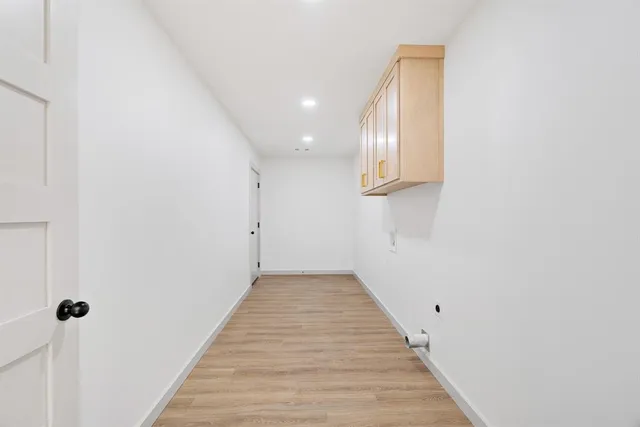 a view of a hallway with wooden floor
