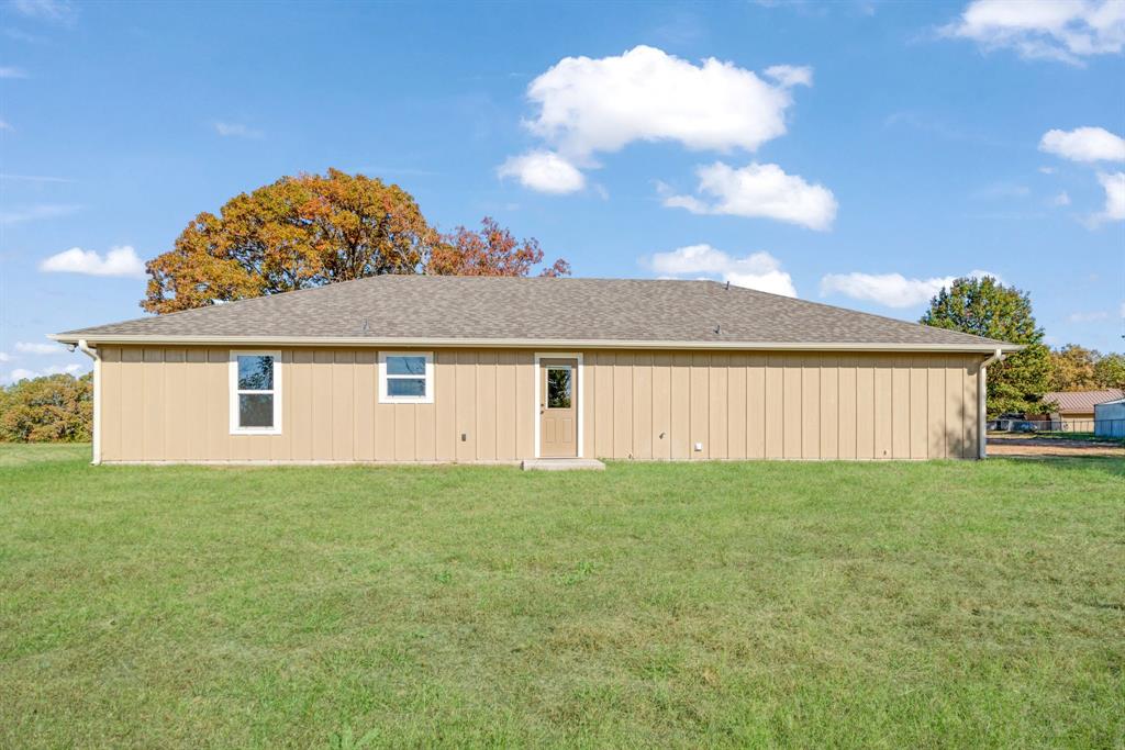 728 County Road Powderly, TX 75473 - Photo 23 of 24 a view of a house with a backyard