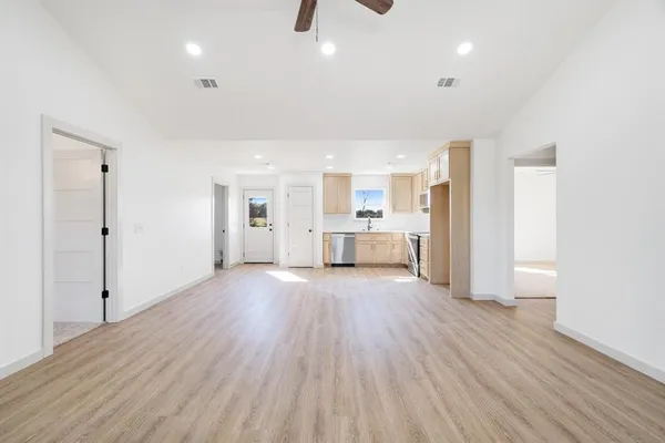a view of a kitchen with wooden floor and a sink