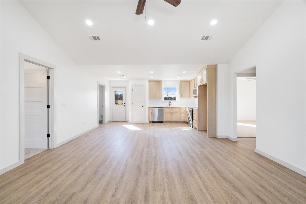 728 County Road Powderly, TX 75473 - Photo 5 of 24 a view of a kitchen with wooden floor and a sink