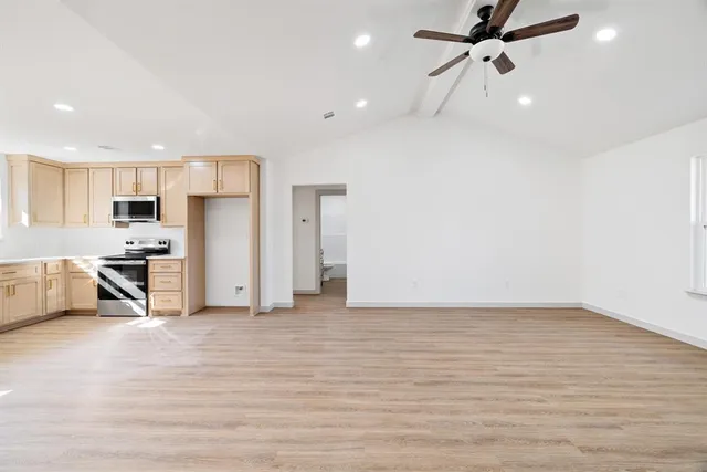 a view of a kitchen with a sink and a refrigerator