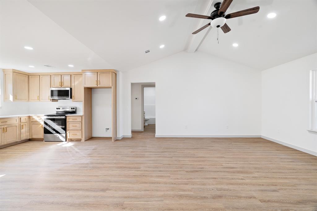 728 County Road Powderly, TX 75473 - Photo 8 of 24 a view of a kitchen with a sink and a refrigerator