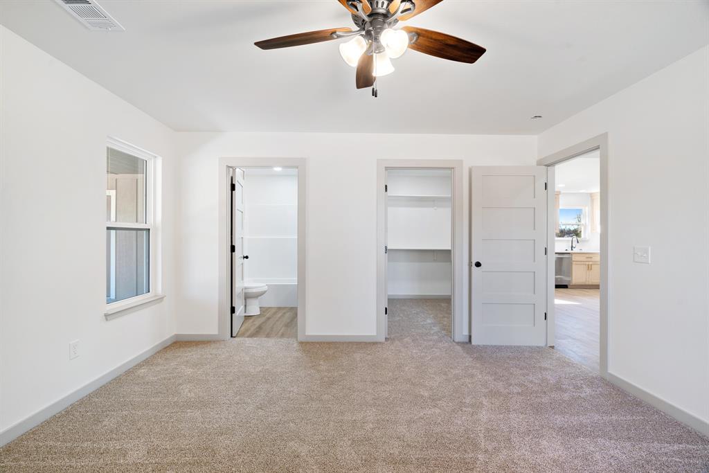 728 County Road Powderly, TX 75473 - Photo 10 of 19 an empty room with closet and windows