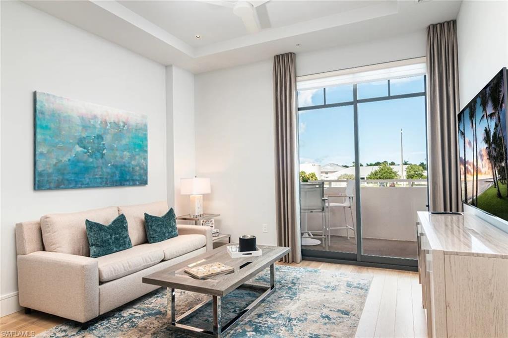 101 8th Street South, Unit 206 Naples, FL 34102 - Photo 1 of 15 a living room with furniture and a large window