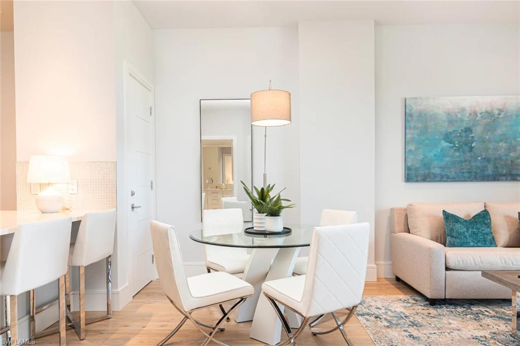 101 8th Street South, Unit 206 Naples, FL 34102 - Photo 5 of 15 a dining room with furniture and wooden floor